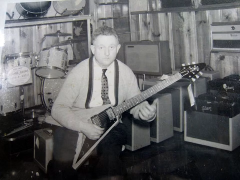 Amos Arthur poses with the 1958 Gibson Flying V at Arthur’s Music Store. Later acquired by Joe Bonamassa, the guitar became known as “Amos” in his honor.