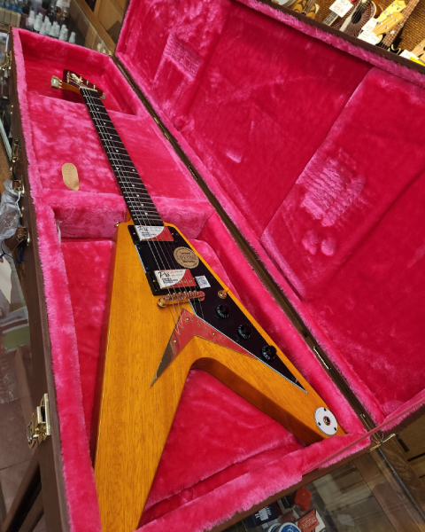 The Epiphone Limited Edition Joe Bonamassa “Amos” 1958 Flying V rests in its fitted, pink-lined case at Arthur’s Music Store.