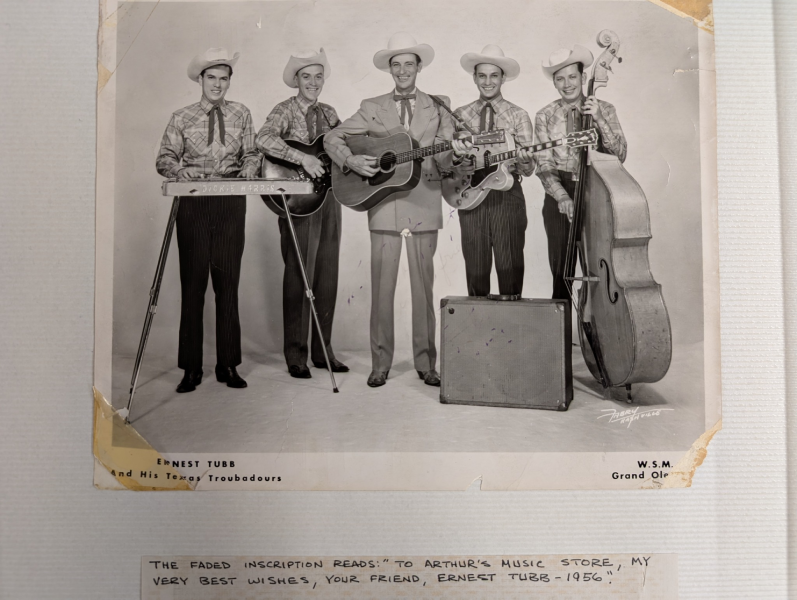 Ernest Tubb and His Texas Troubadours in a publicity photograph inscribed to Arthur’s Music Store, circa 1956. The accompanying note records the faded inscription: “To Arthur’s Music Store, my very best wishes, your friend, Ernest Tubb—1956.”