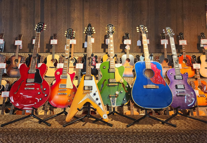 A colorful display of new Epiphone guitars at Arthur’s Music Store. From left: ES-335, 1959 Les Paul Standard, 1958 Korina Flying V, Emperor Swingster, Miranda Lambert Bluebird, and Modern Figured Les Paul.