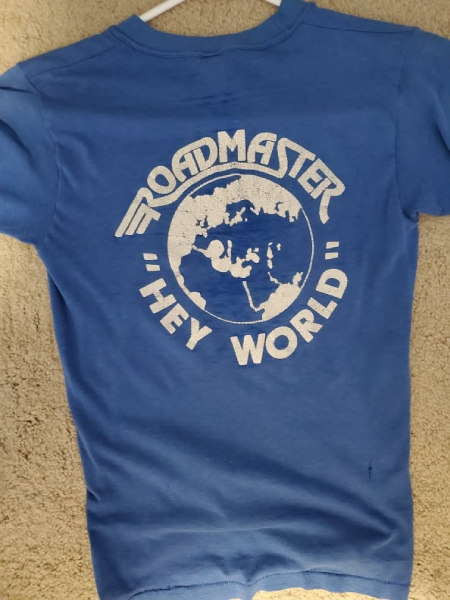 The back of a vintage Roadmaster *Hey World* T-shirt features the band’s logo surrounding a globe. Photo courtesy of Brad Farber.