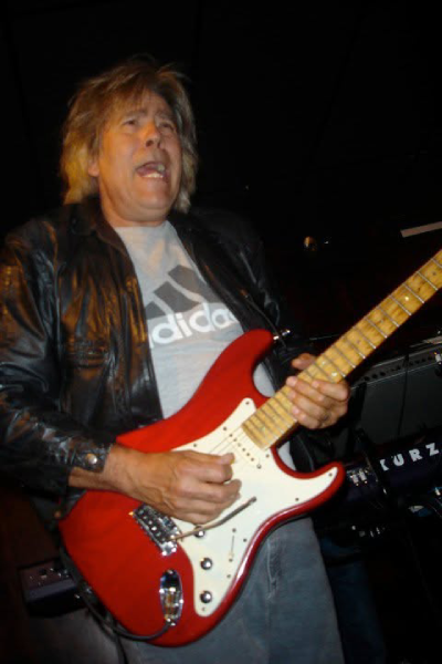 Roadmaster guitarist Ricky Benick rocks out during a live performance.